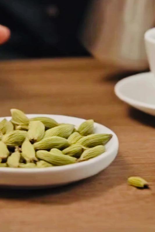 FRESHLY GROUND PREMIUM ARABICA BEANS + CARDAMOM.